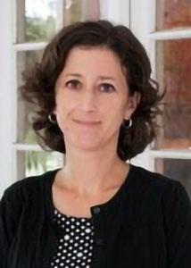 Headshot of Jennifer Glick with short brown hair, a black polka-dot shirt and a cardigan.