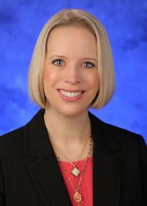 Headshot of Jennifer Kraschnewski with short golden hair in black blazer.
